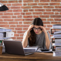 Tired Businesswoman Surrounded by work